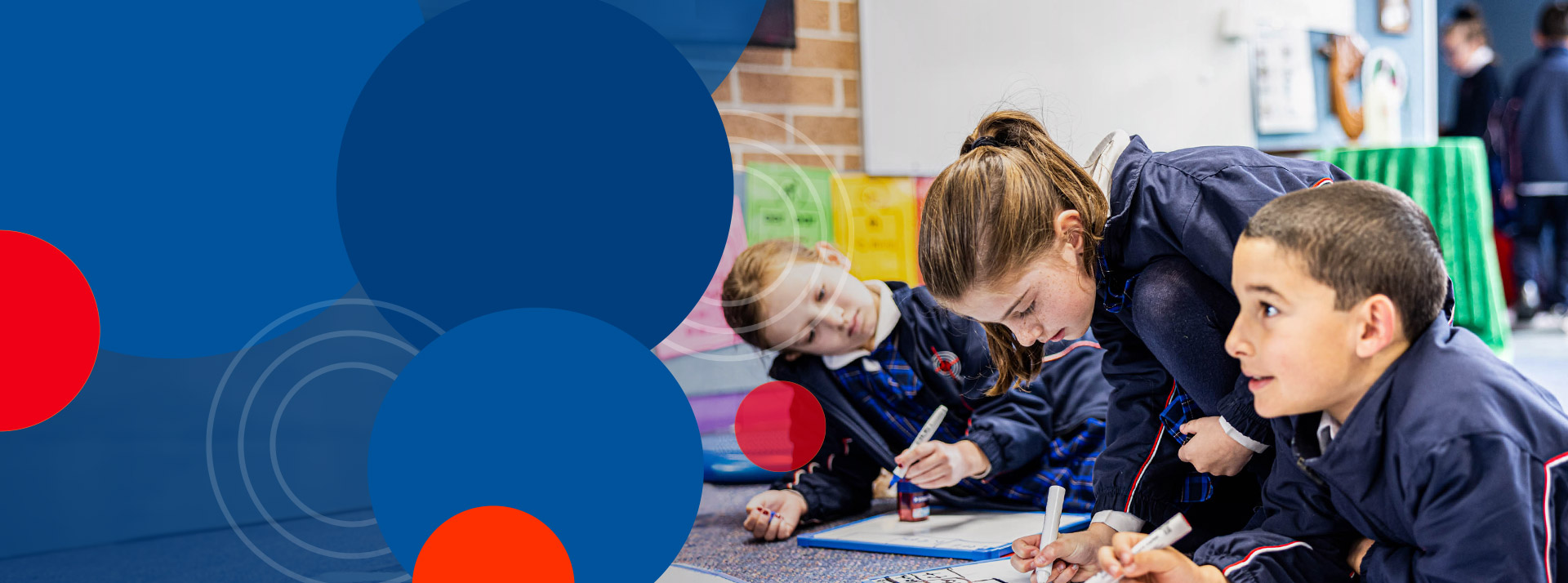 Students sitting on the floor together at Bethany Catholic Primary School Glenmore Park