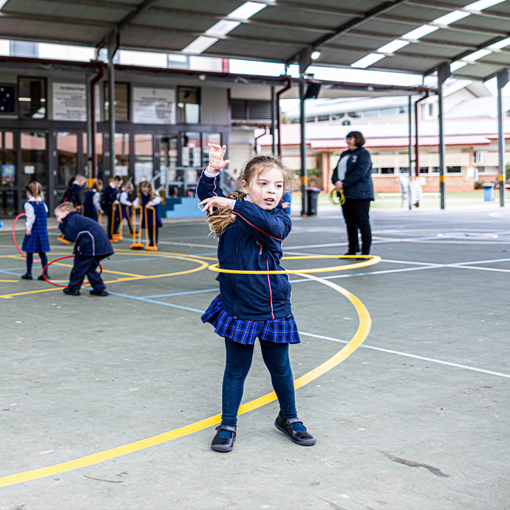 Student playing with hula hoop at Bethany Catholic Primary School Glenmore Park