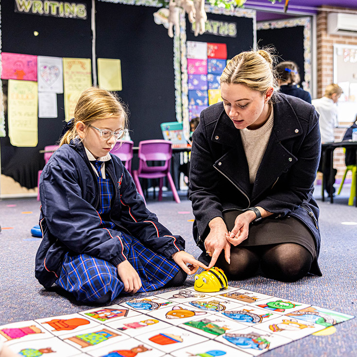 Teacher and student with Beebots at Bethany Catholic Primary School Glenmore Park