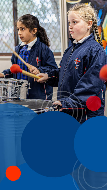 Students playing the drums in music class at Bethany Catholic Primary School Glenmore Park