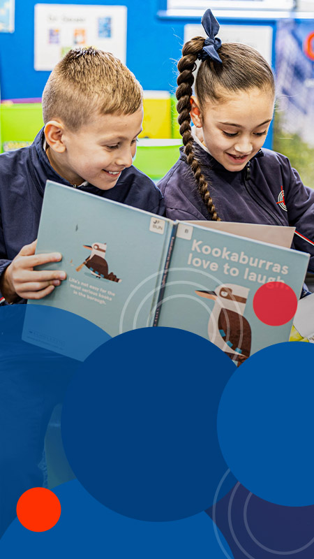 Students reading a book together at Bethany Catholic Primary School Glenmore Park